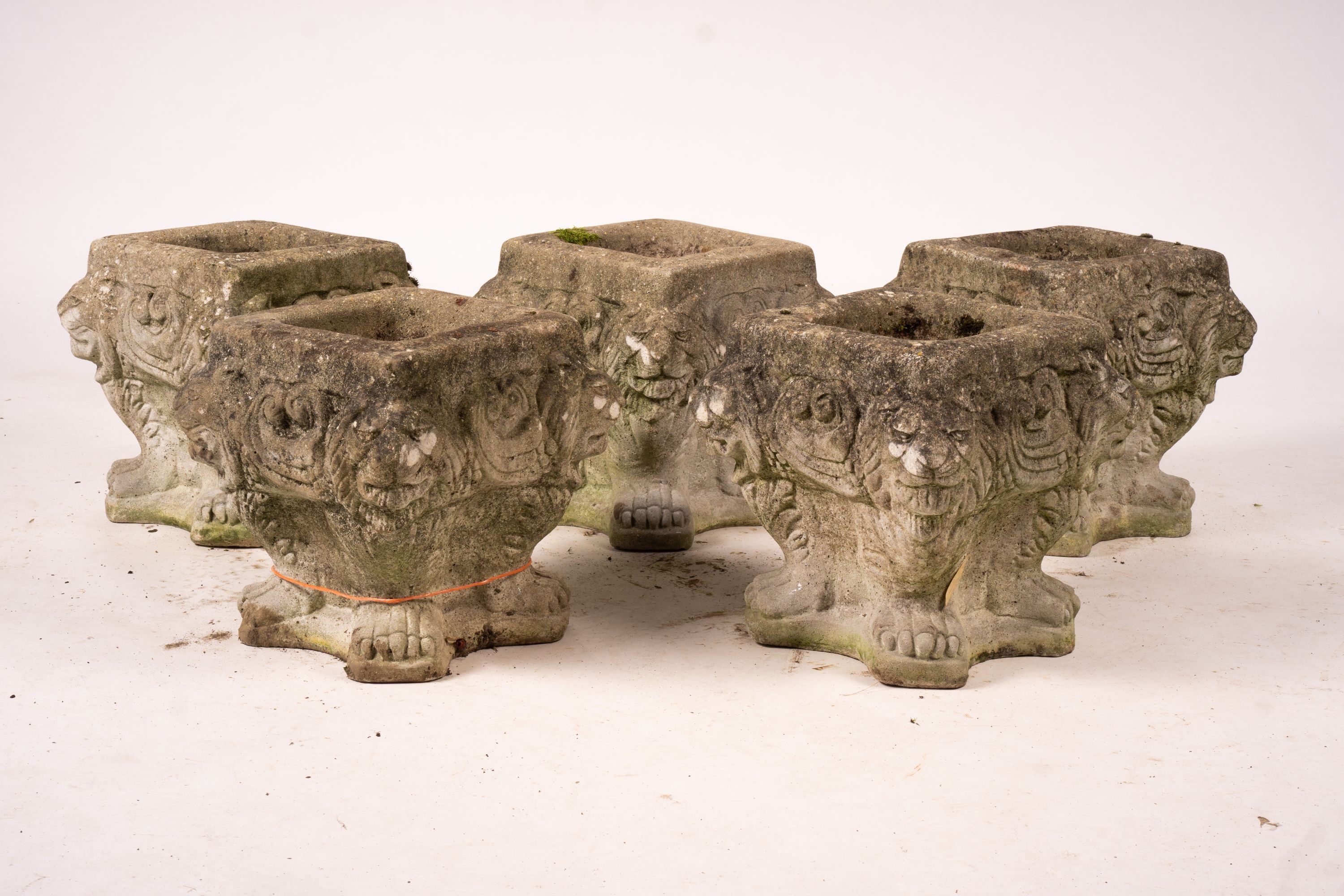 A set of five reconstituted stone lion mask square garden planters, W.30cm H.32cm